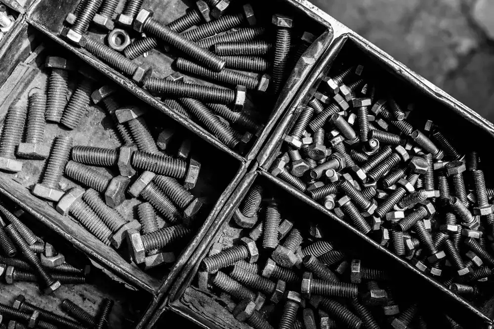 Tidy shop shelves holding boxes of fasteners and arranged hand tools