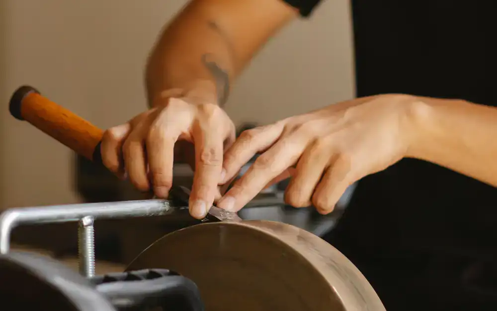 Sharpening a chisel blade on a stone
