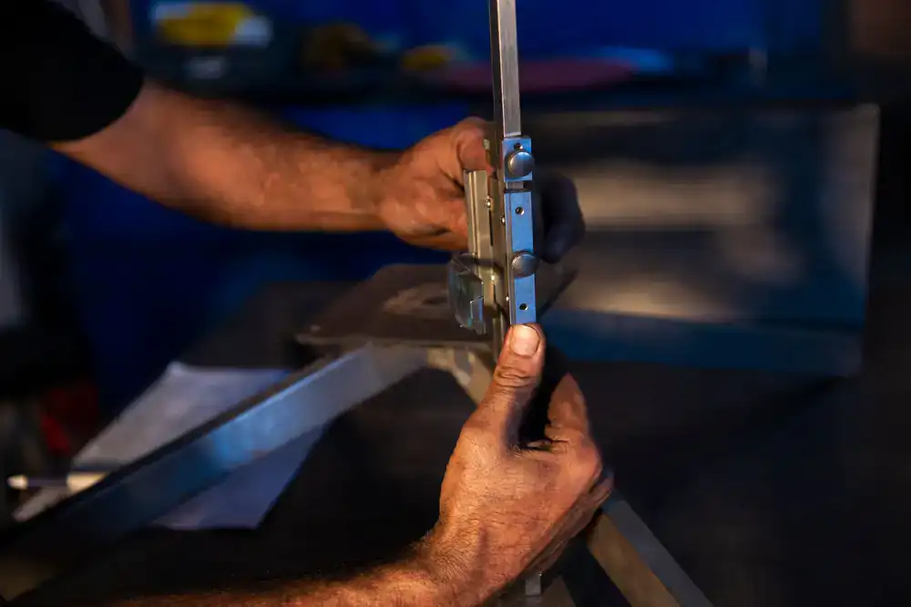 Hands working on a brass fixture in the shop